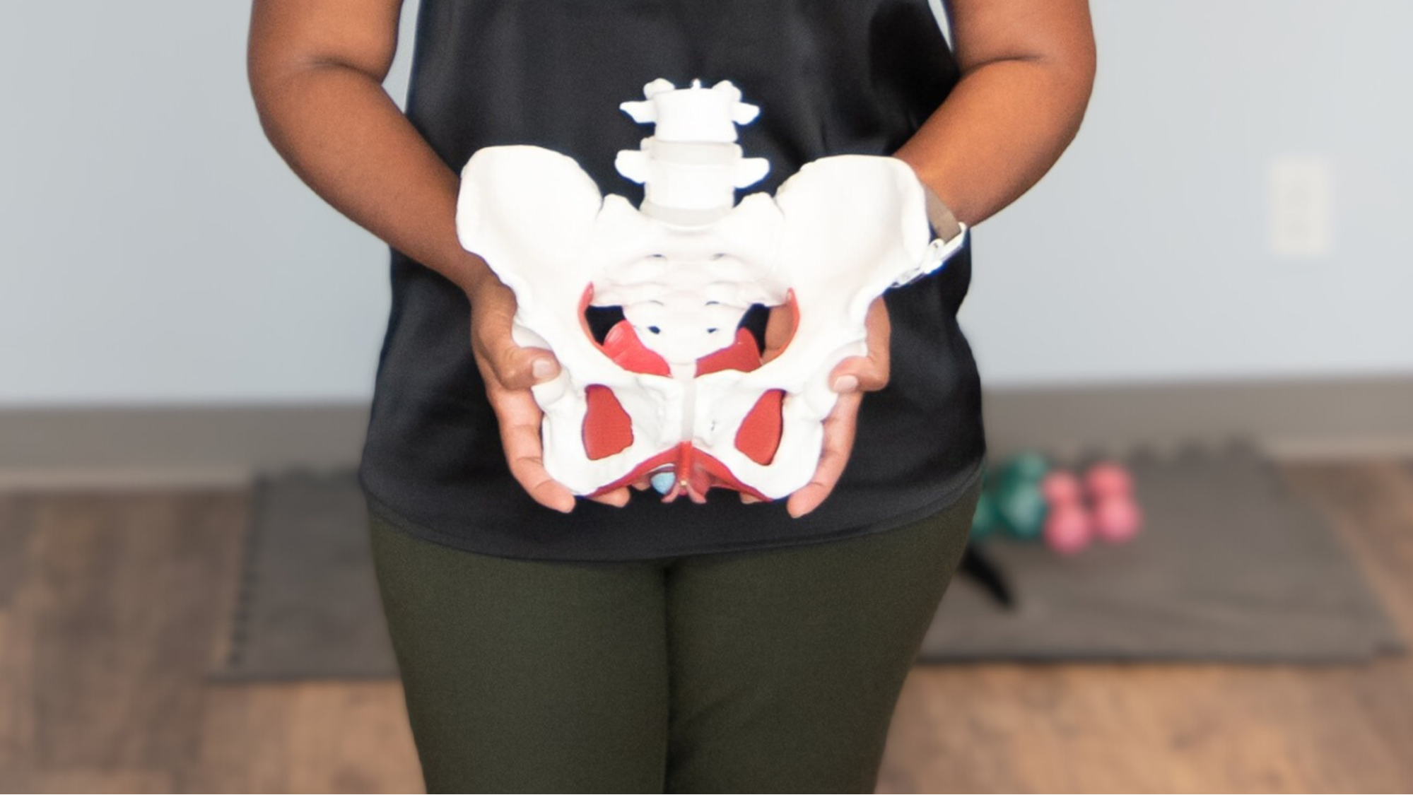 Woman holding pelvis skeleton